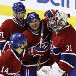 Montreal Canadiens goalie Carey Price is congratulated on his win by teammates following NHL hockey overtime shootout action against Pittsburgh Penguins in Montreal